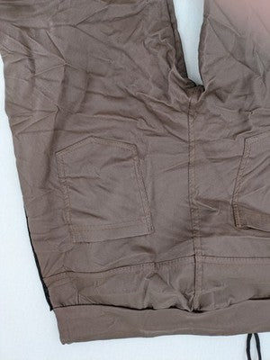 TREDY brown pants with black side stripes, silver studs, and adjustable drawstring.