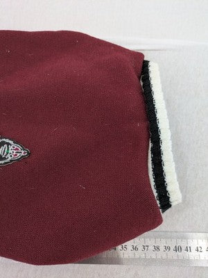 Burgundy dog sweater fleece lined with black and white striped trim, embroidered patch detail.