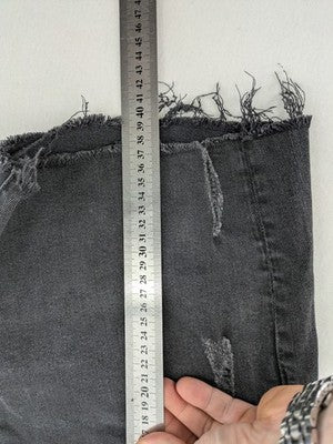 H&M black distressed skinny jeans shorts with frayed hem and button fly detail.