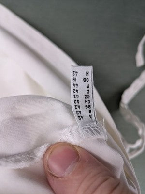 Marco Pecci white A-line dress with collar, adjustable drawstring waist, and utility pockets.
