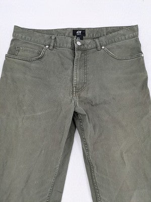 H&M khaki skinny fit jeans with classic five-pocket design and stretch cotton material.