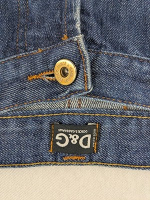 Dolce & Gabbana blue bootcut jeans with suede logo patch and classic 5-pocket design.