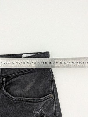 H&M black distressed skinny jeans shorts with frayed hem and button fly detail.