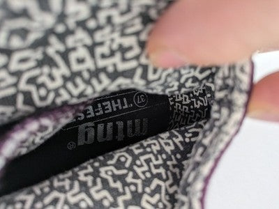 Mtng high top sneakers purple canvas with black laces and patterned white lining.