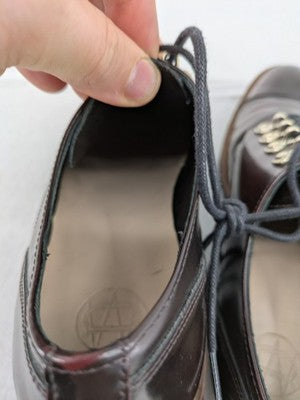 Massimo Dutti brown deck shoes glossy leather cap toe with metallic eyelets and rugged sole.