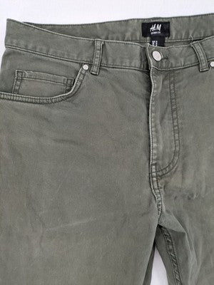 H&M khaki skinny fit jeans with classic five-pocket design and stretch cotton material.