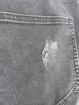 H&M black distressed skinny jeans shorts with frayed hem and button fly detail.