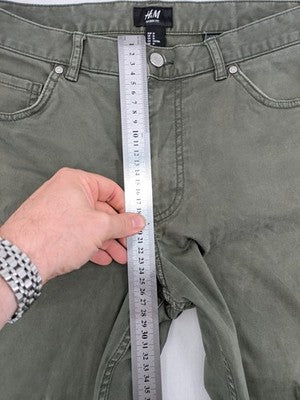 H&M khaki skinny fit jeans with classic five-pocket design and stretch cotton material.