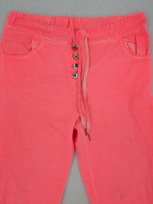 Pink Cherry pink jogpants with elastic waistband, decorative button placket, and rolled cuffs.