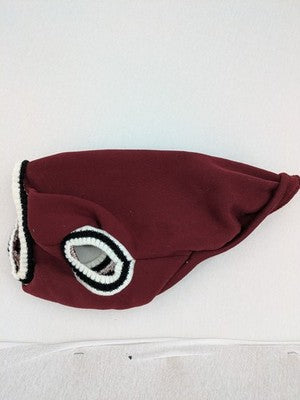Burgundy dog sweater fleece lined with black and white striped trim, embroidered patch detail.