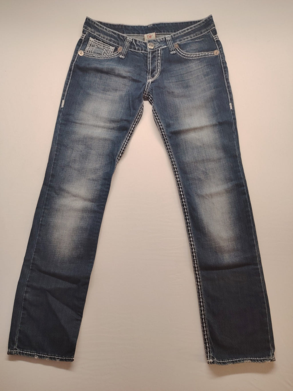 Mixed secondhand jeans in black, brown, and grey with various brand labels and styles.