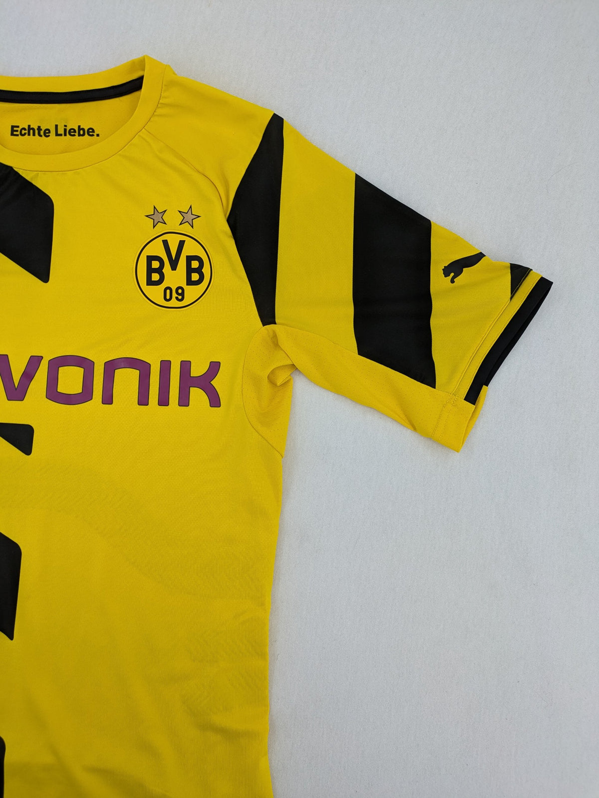 Puma black and yellow Borussia Dortmund soccer jersey with logo, stars, and sponsor print.