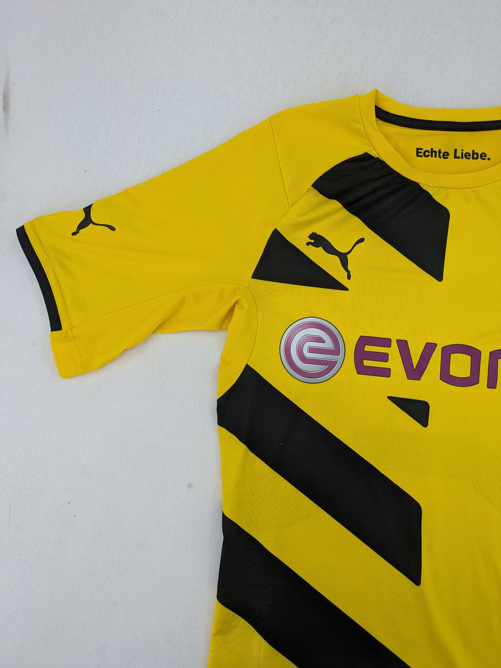 Puma black and yellow Borussia Dortmund soccer jersey with logo, stars, and sponsor print.