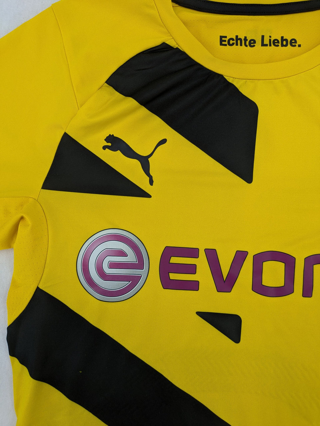 Puma black and yellow Borussia Dortmund soccer jersey with logo, stars, and sponsor print.