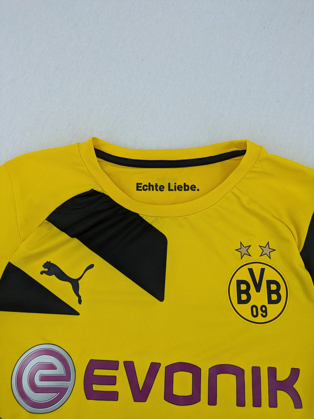 Puma black and yellow Borussia Dortmund soccer jersey with logo, stars, and sponsor print.