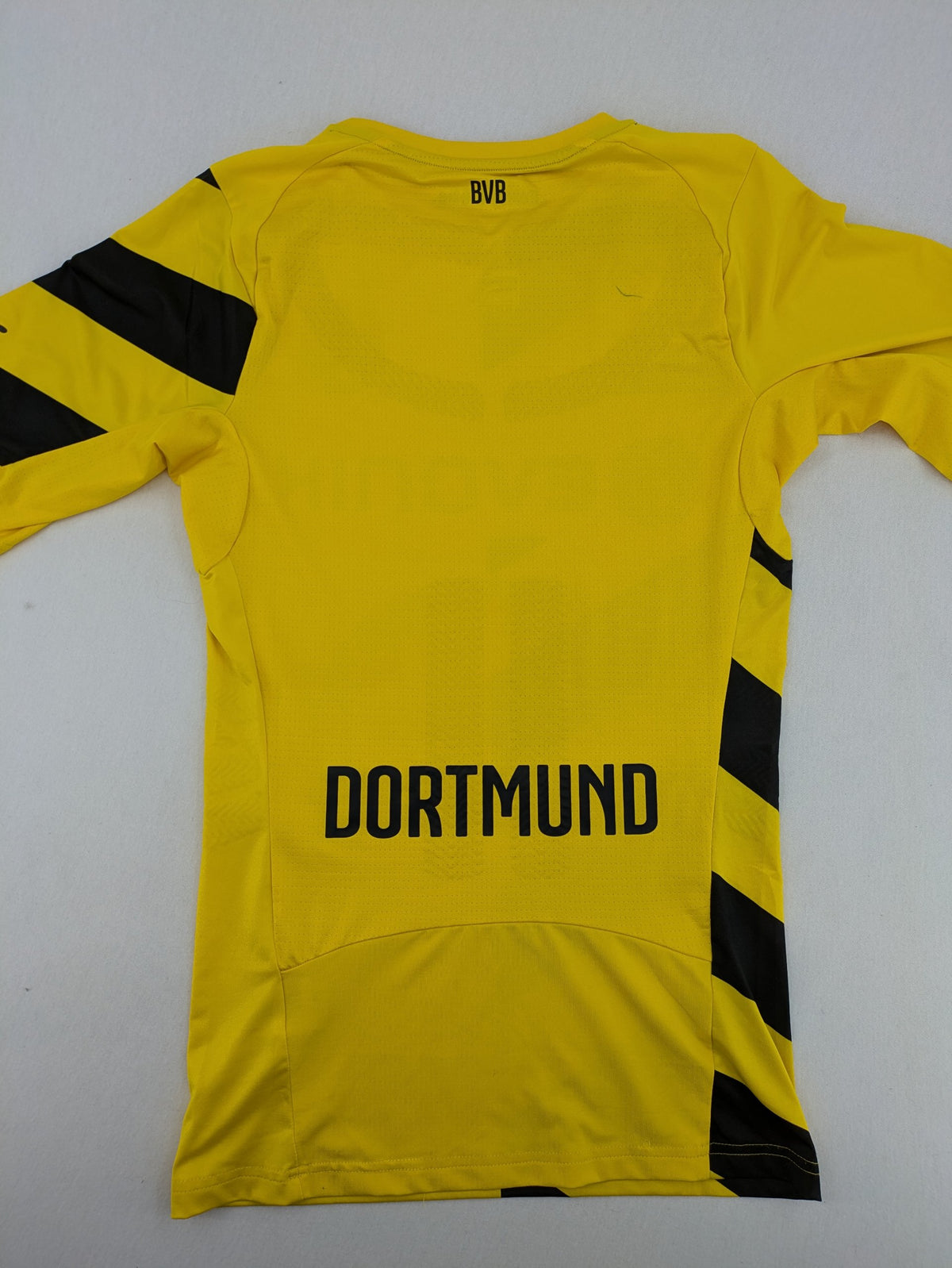 Puma black and yellow Borussia Dortmund soccer jersey with logo, stars, and sponsor print.