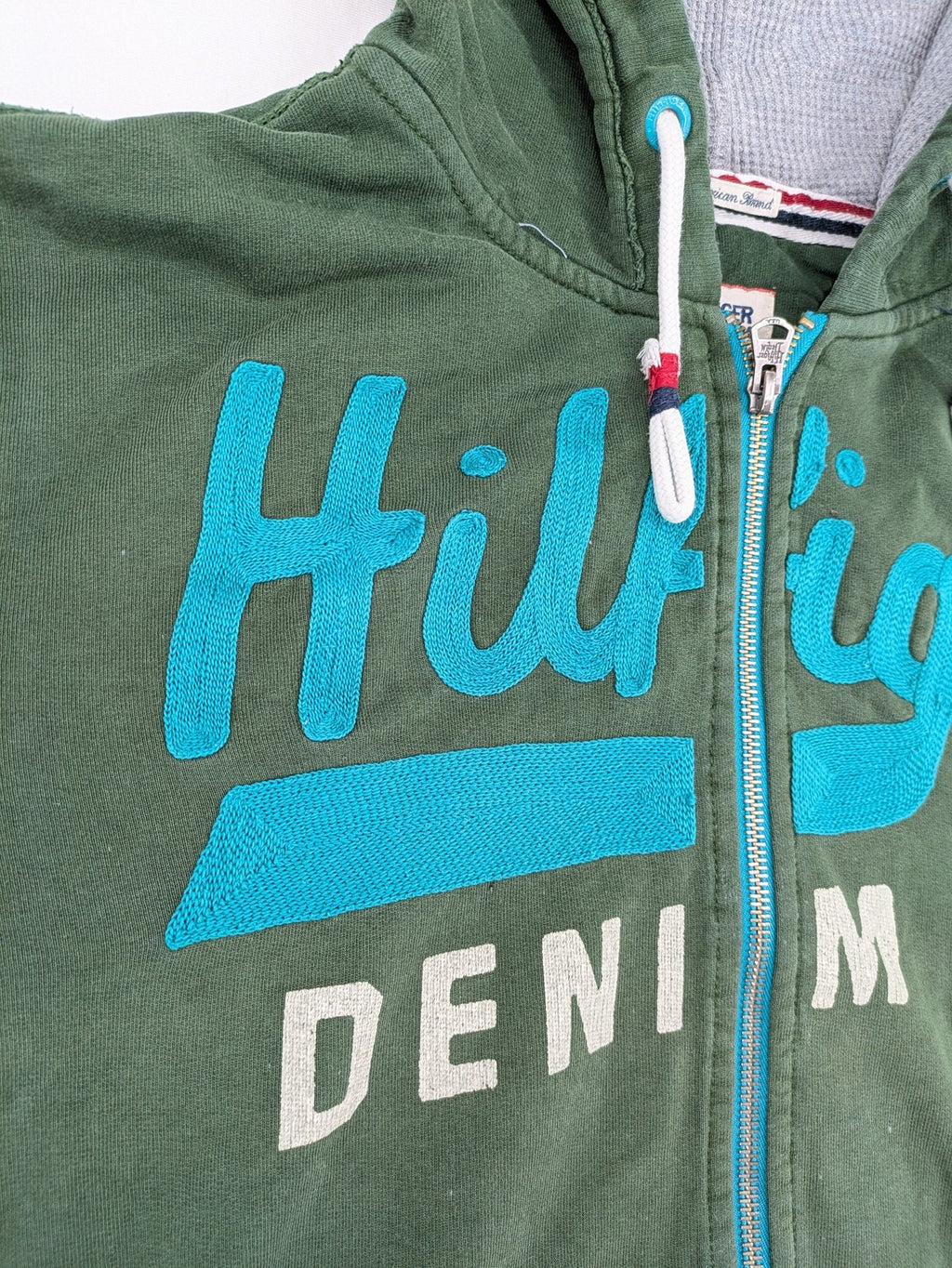 Tommy Hilfiger Denim green hoodie full zip with large graphic logo and grey waffle lining.