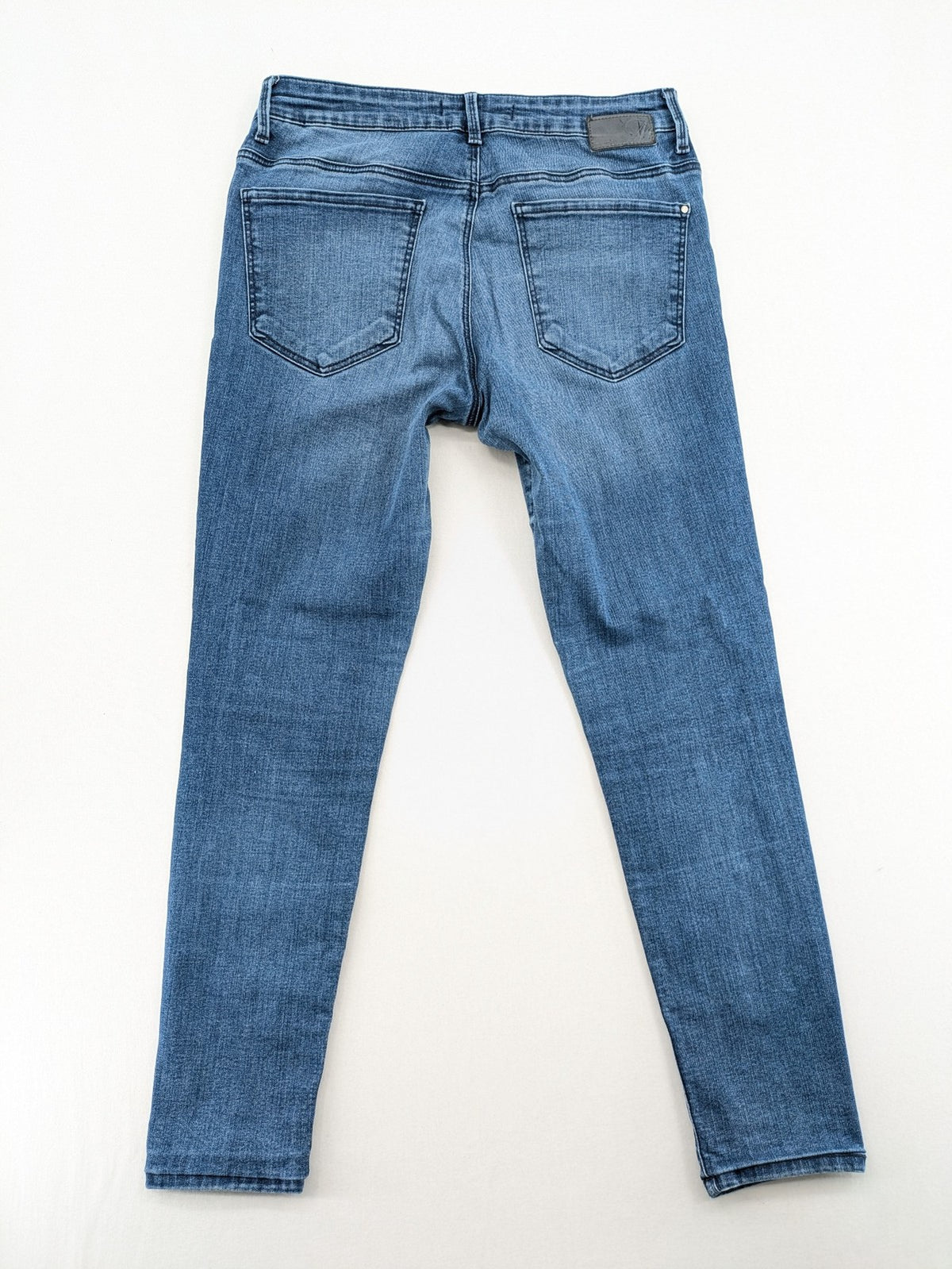 Mavi blue high rise super skinny jeans with medium wash and stretch denim material.