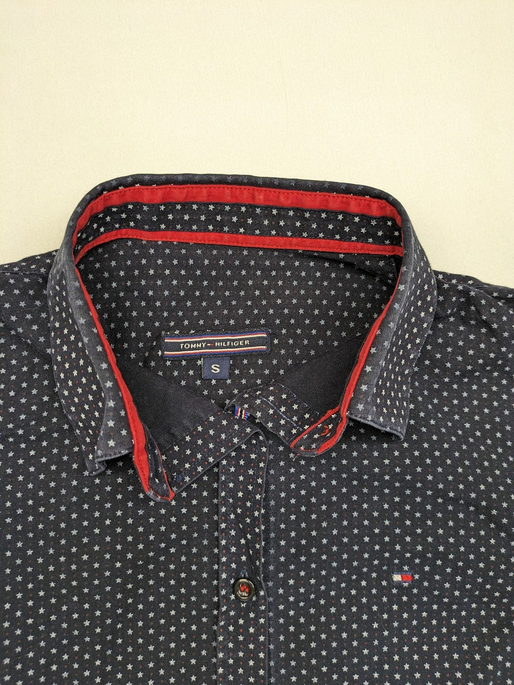 Tommy Hilfiger navy button-down shirt with white star pattern and embroidered flag logo.