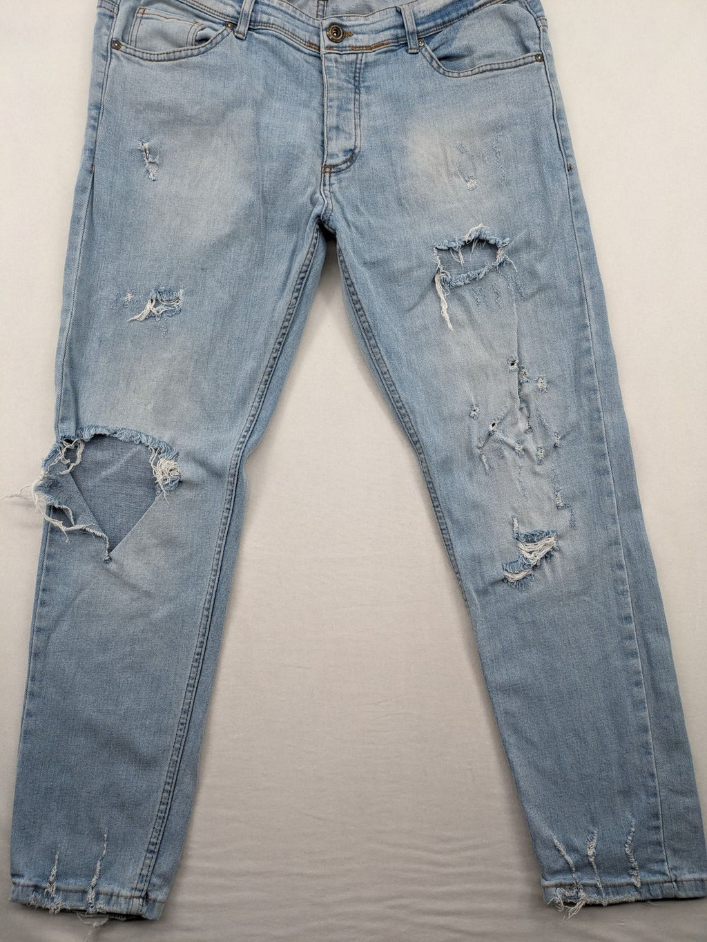i8 Denim blue straight jeans destroyed look with frayed hems and classic button fly.