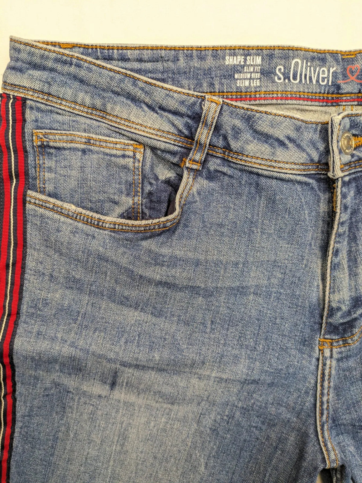 s.Oliver blue straight jeans with red and white side stripes, soft cotton blend material