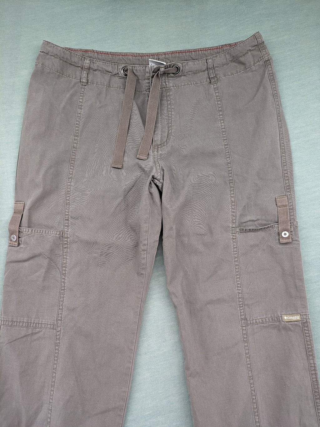 Columbia grey cargo pants with multiple pockets and drawstring waist, 100% cotton.