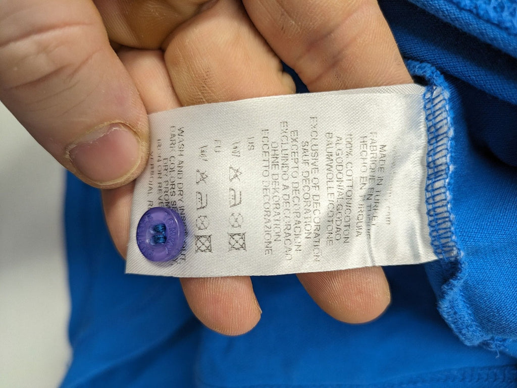 Tommy Hilfiger blue polo shirt with white stripes and embroidered logo on chest.