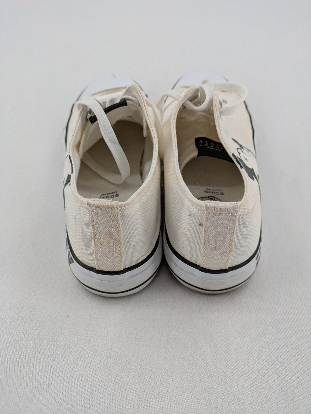 Disney Mickey Mouse white canvas low top sneakers with iconic Mickey Mouse graphic.