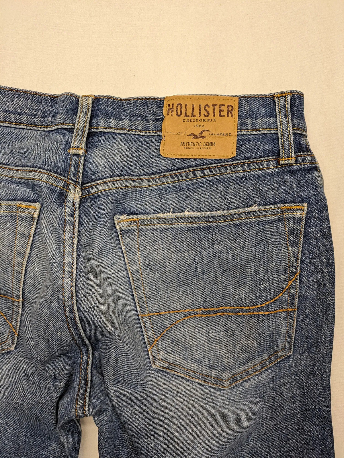 Hollister blue slim fit jeans with distressed detailing and classic button fly.