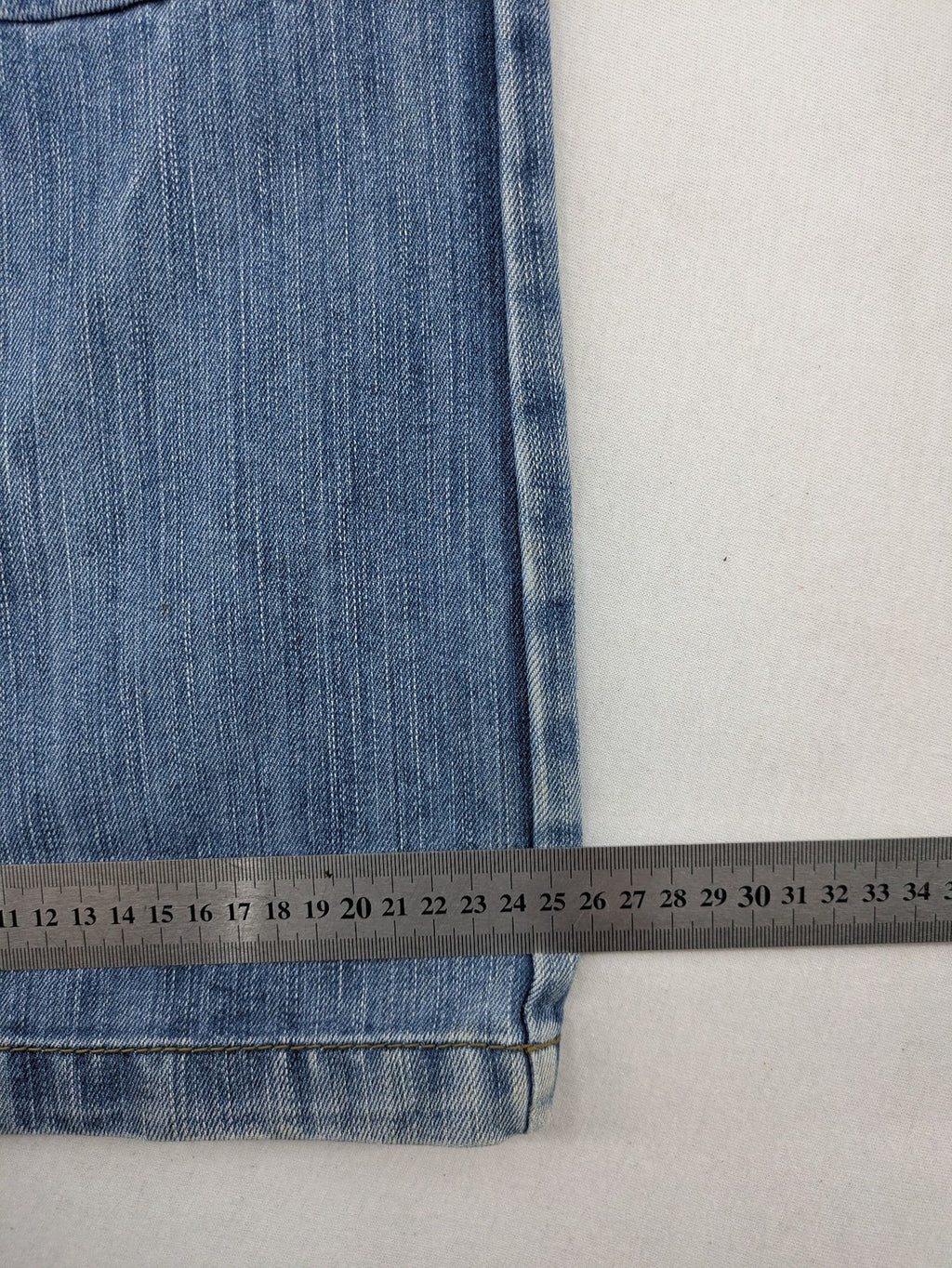 Premium Denim blue straight leg jeans with biker knee inserts and five-pocket design.