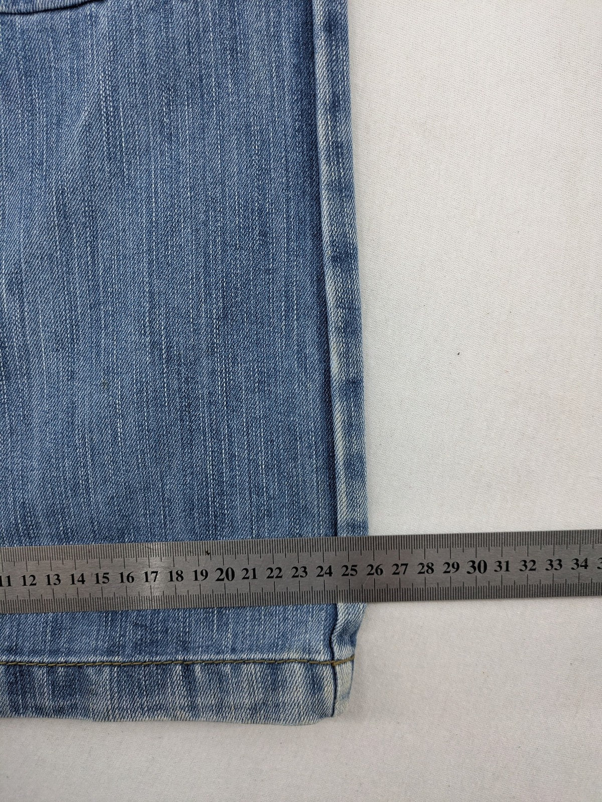 Premium Denim blue straight leg jeans with biker knee inserts and five-pocket design.
