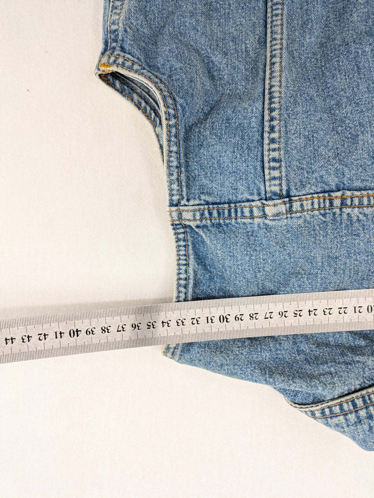 s.Oliver blue denim vest with button closure, pointed collar, and breast pockets.