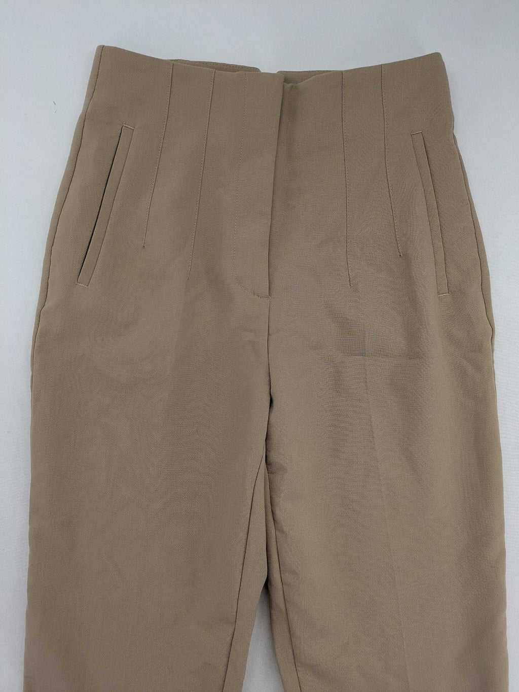 Tapered beige pants high-waist tapered fit with classic front creases and side pockets.