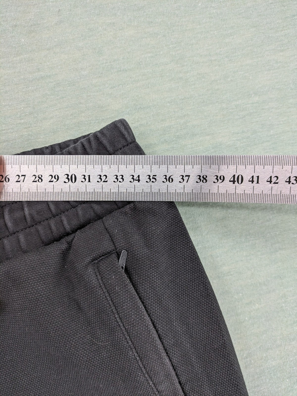 Puma grey sweatshorts featuring Mercedes AMG Petronas logo and elastic waistband.