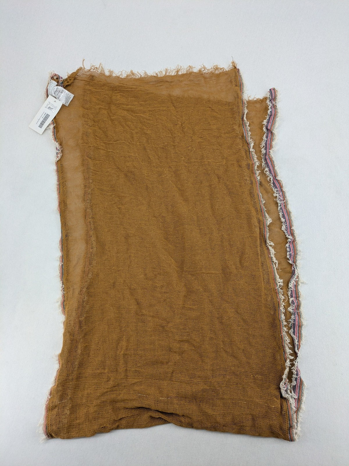 Romano multi scarf ocker with multicolored striped border and fringed edges.