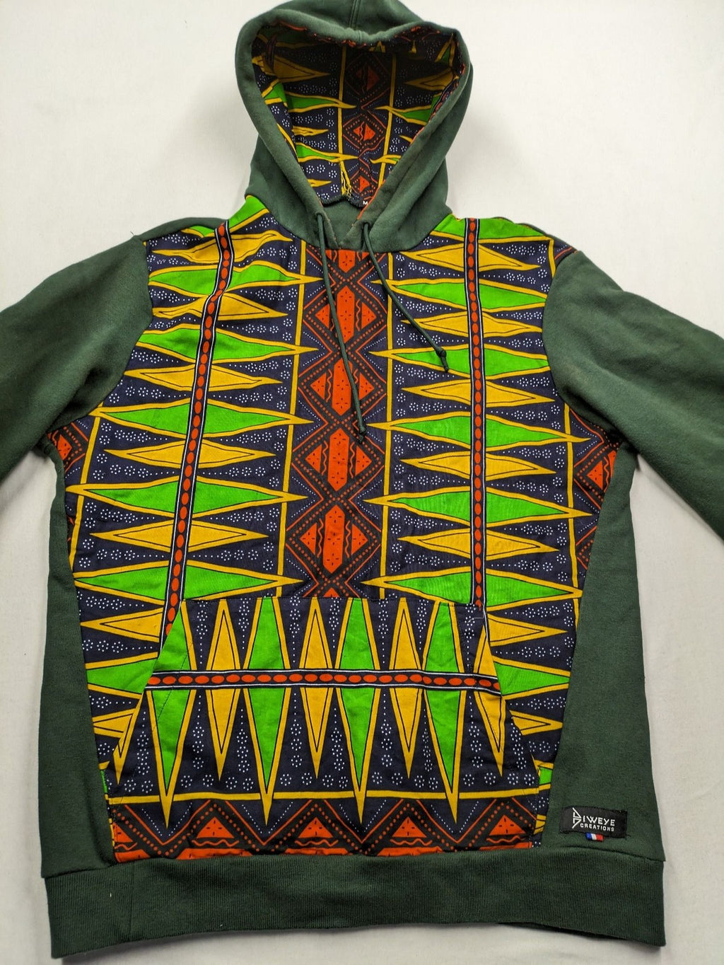 Diweye Creations multi turtle neck jumper with vibrant African print and soft green material.