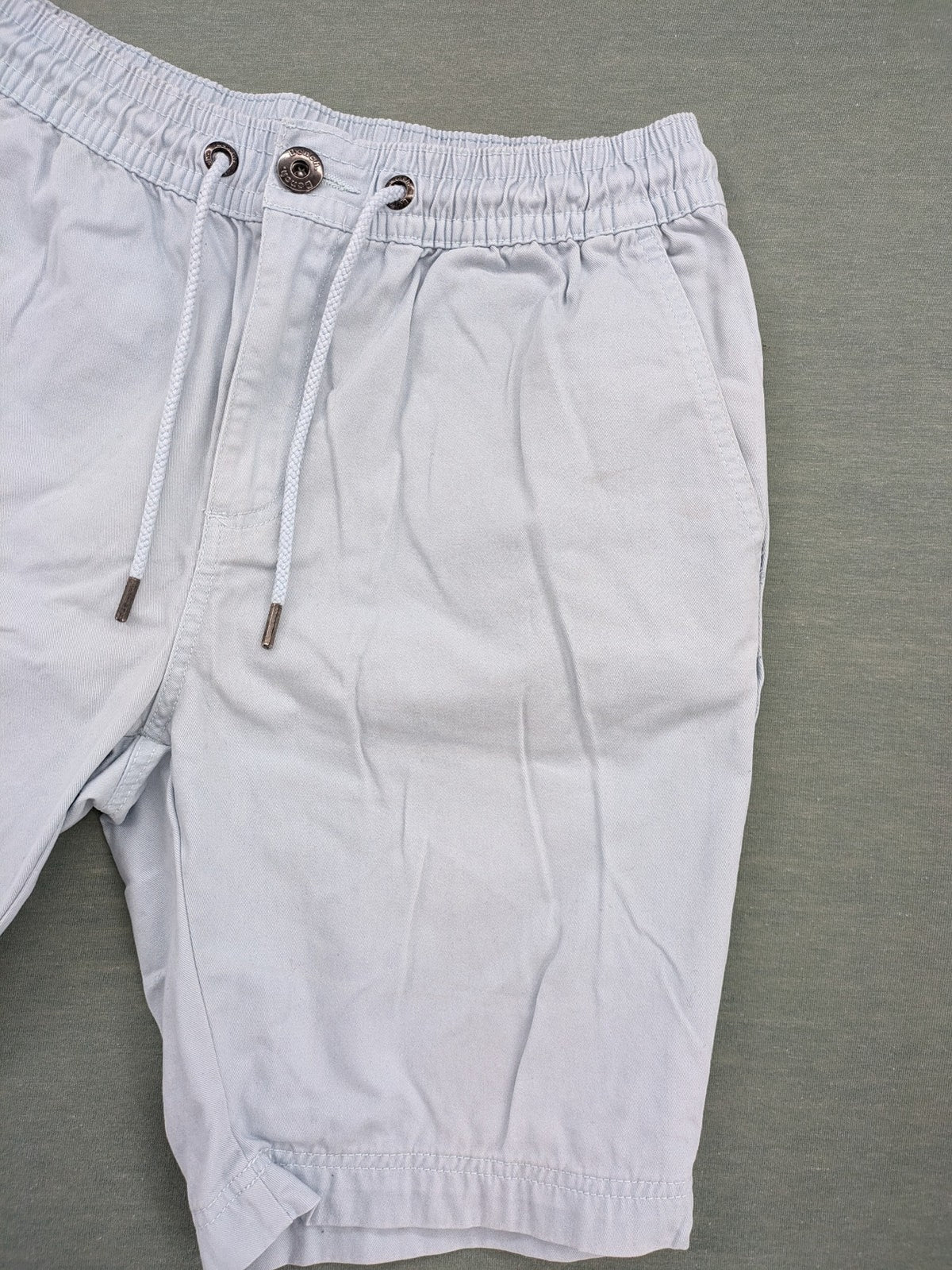 Bench blue shorts with elastic waistband, drawstring, and multiple pockets.