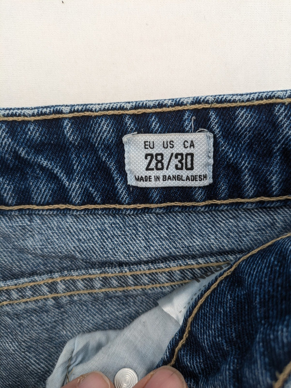 FSBN blue straight jeans with distressed knee rips and classic button fly.