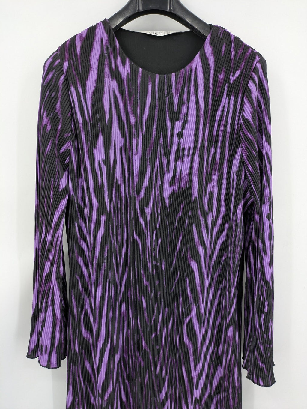 Untold black and purple pleated dress with animal print pattern and long sleeves.