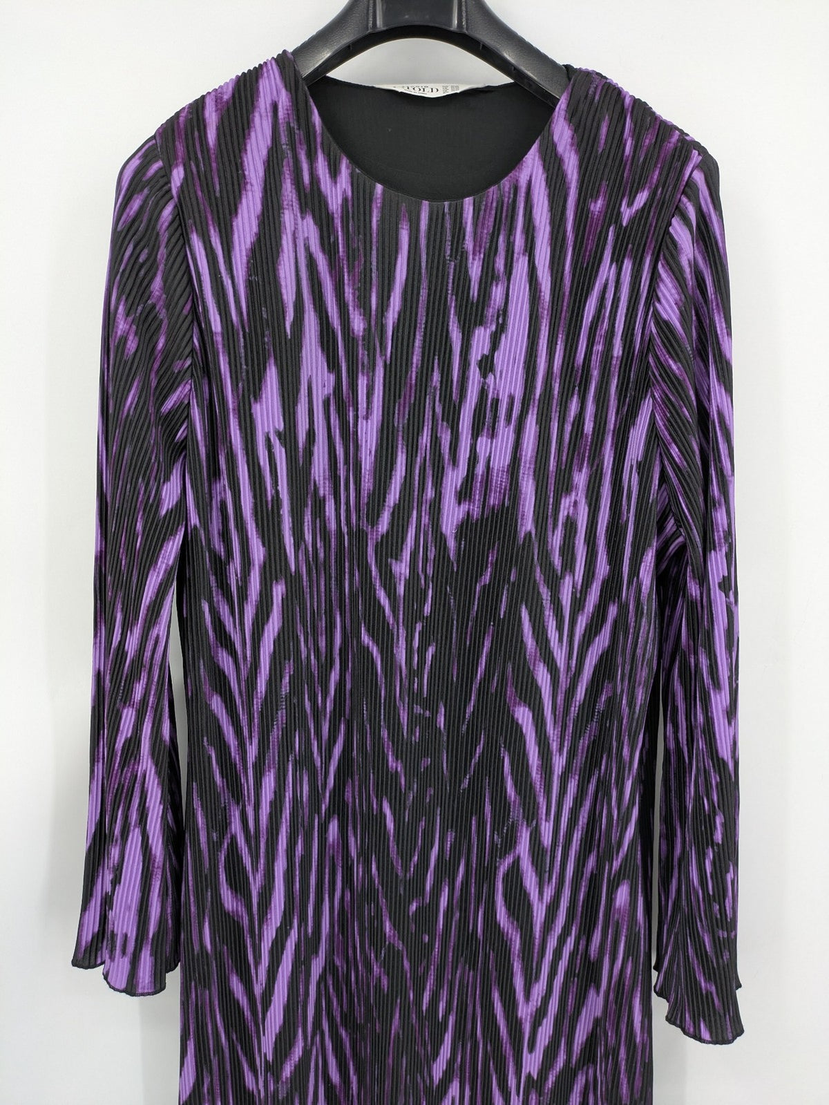 Untold black and purple pleated dress with animal print pattern and long sleeves.