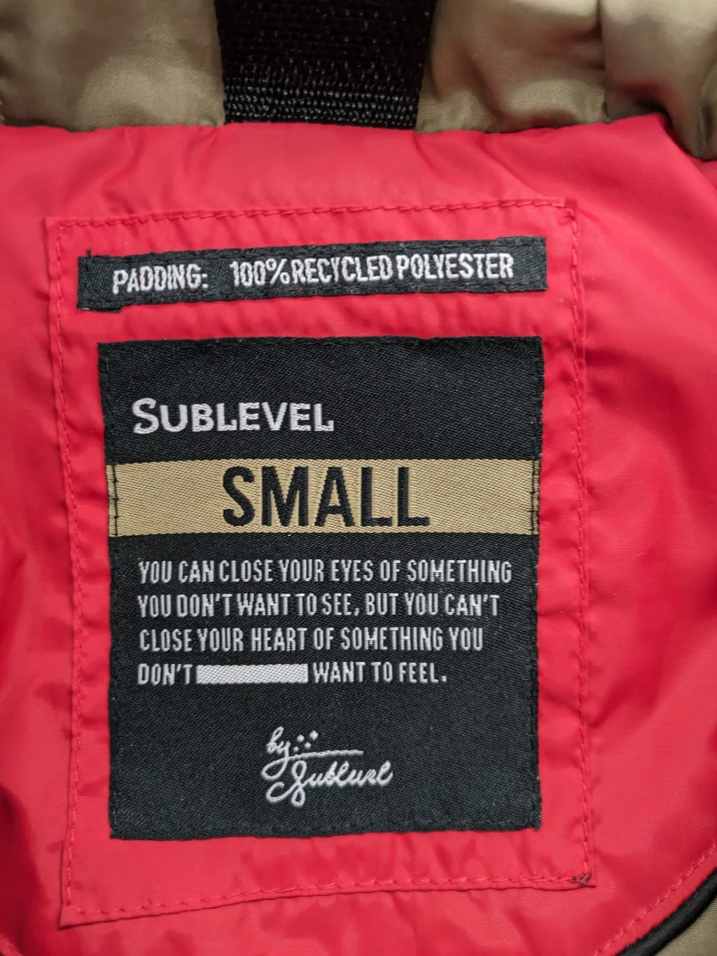 Sublevel red puffer jacket size S, chevron quilted pattern, adjustable hood, recycled polyester lining.