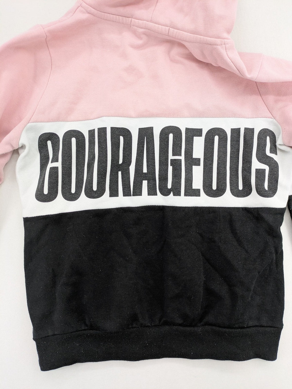 FB Sister multi hoodie colorblock design pink, white, black with "COURAGEOUS" graphic print.