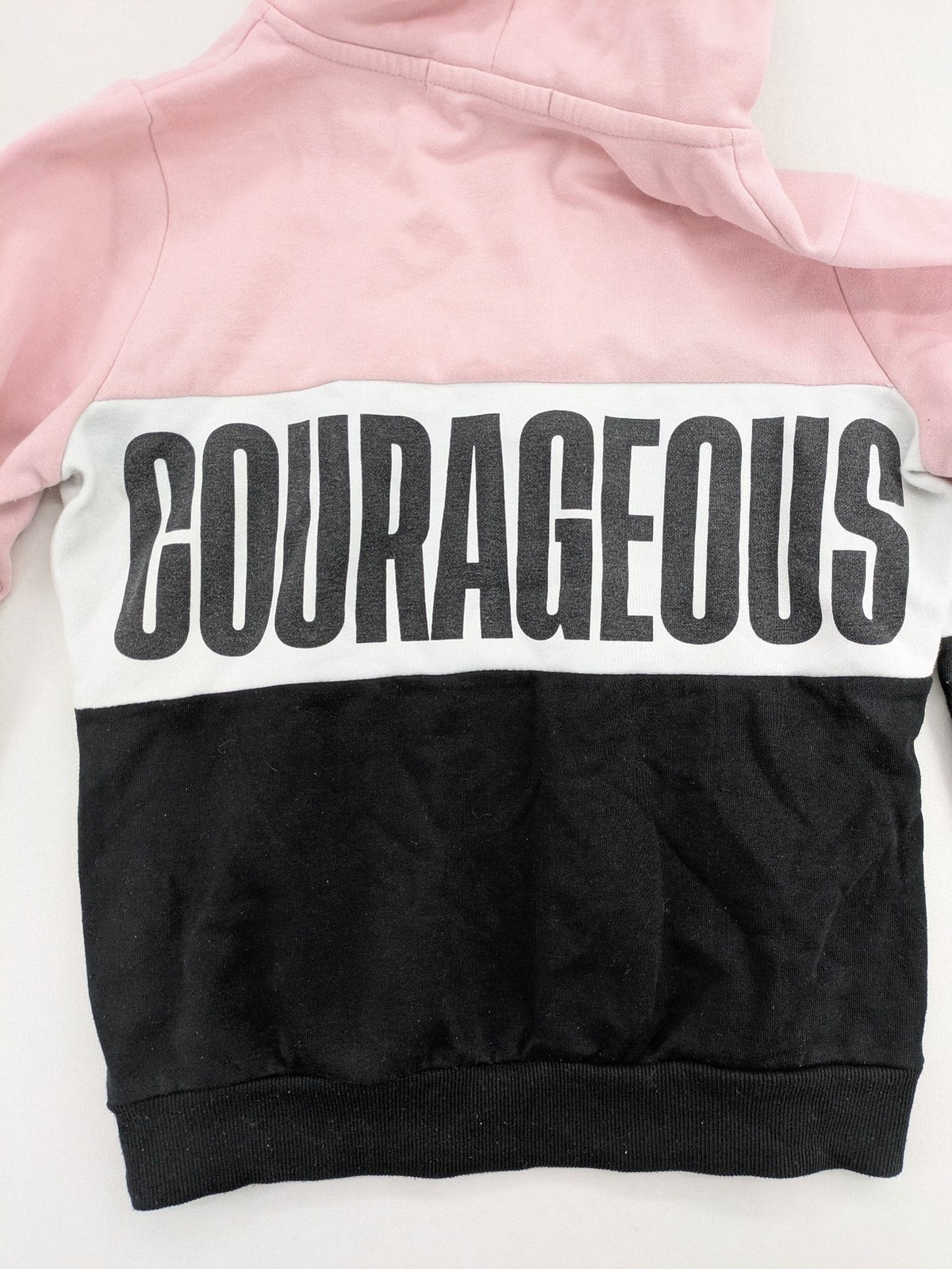 FB Sister multi hoodie colorblock design pink, white, black with "COURAGEOUS" graphic print.