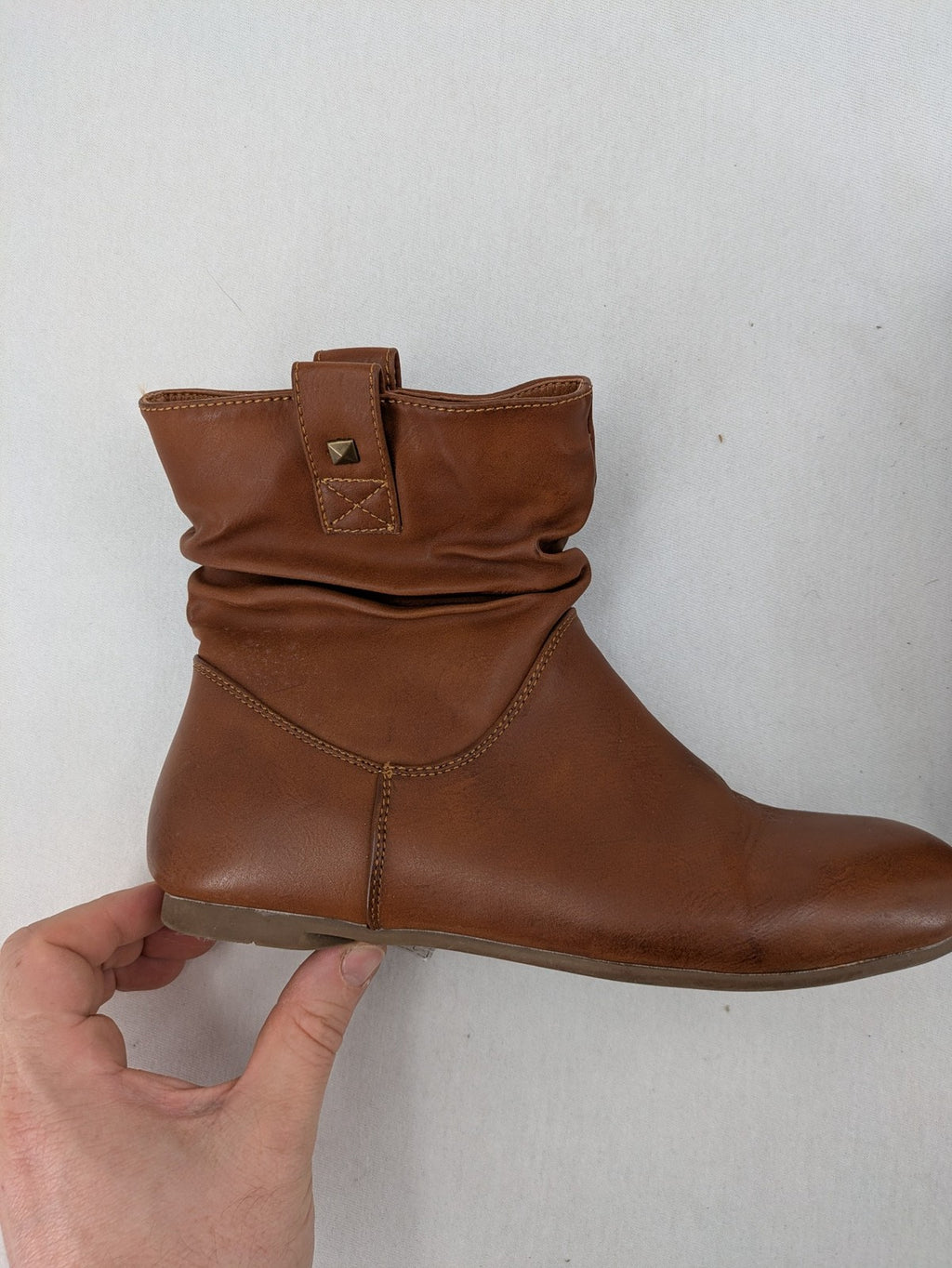 Van Hill brown ankle boots with slouchy design, fold-over cuff, and soft lining.