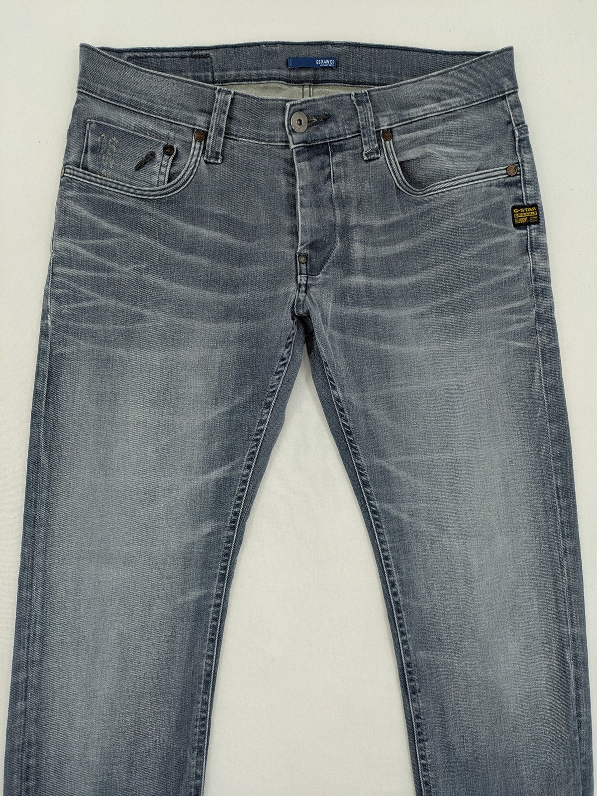 G-Star Raw grey denim straight jeans with classic button fly and subtle branding details.