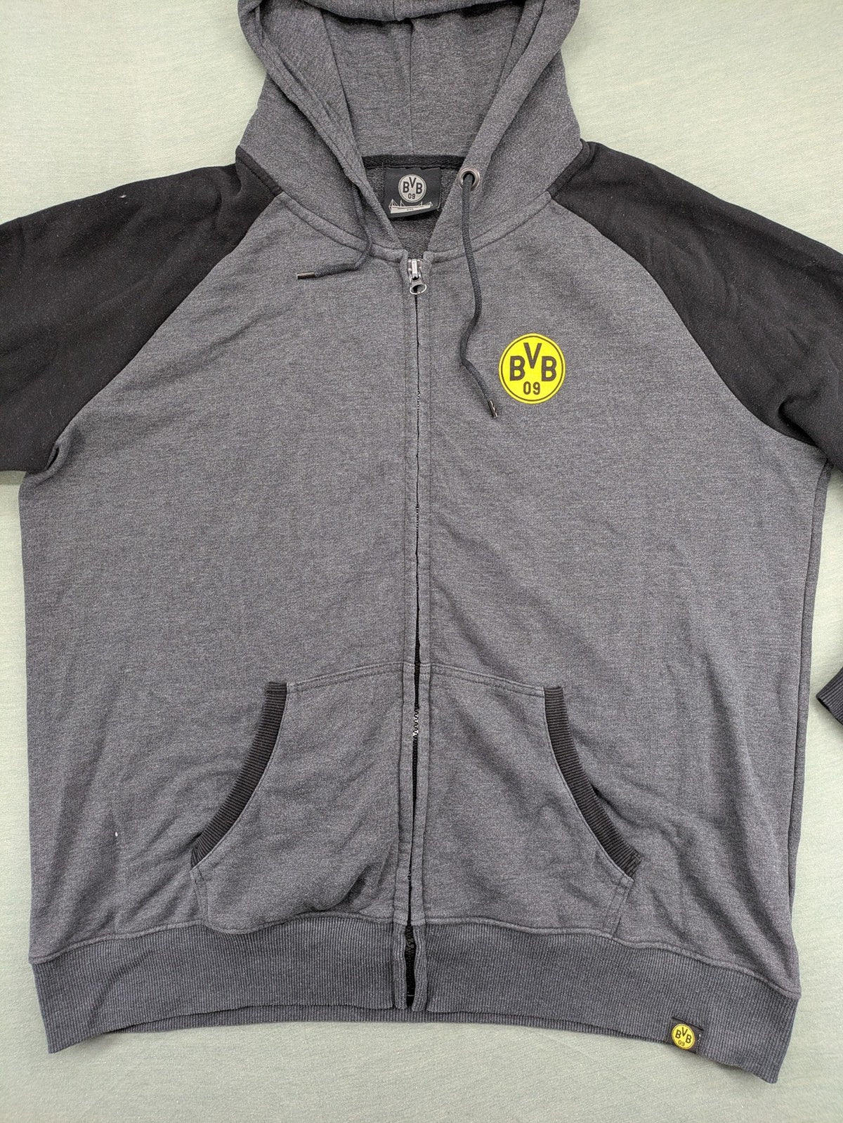 Borussia Dortmund grey and black hoodie with BVB 09 logo and full zip design.