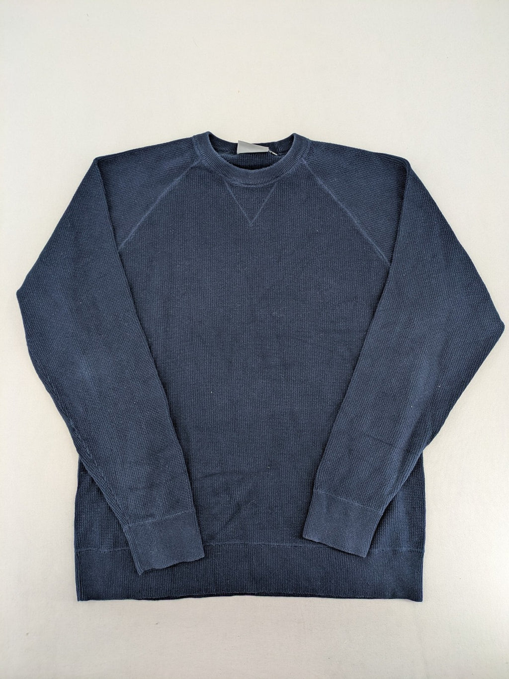 Carhartt navy turtle neck jumper waffle knit texture with subtle logo on sleeve.