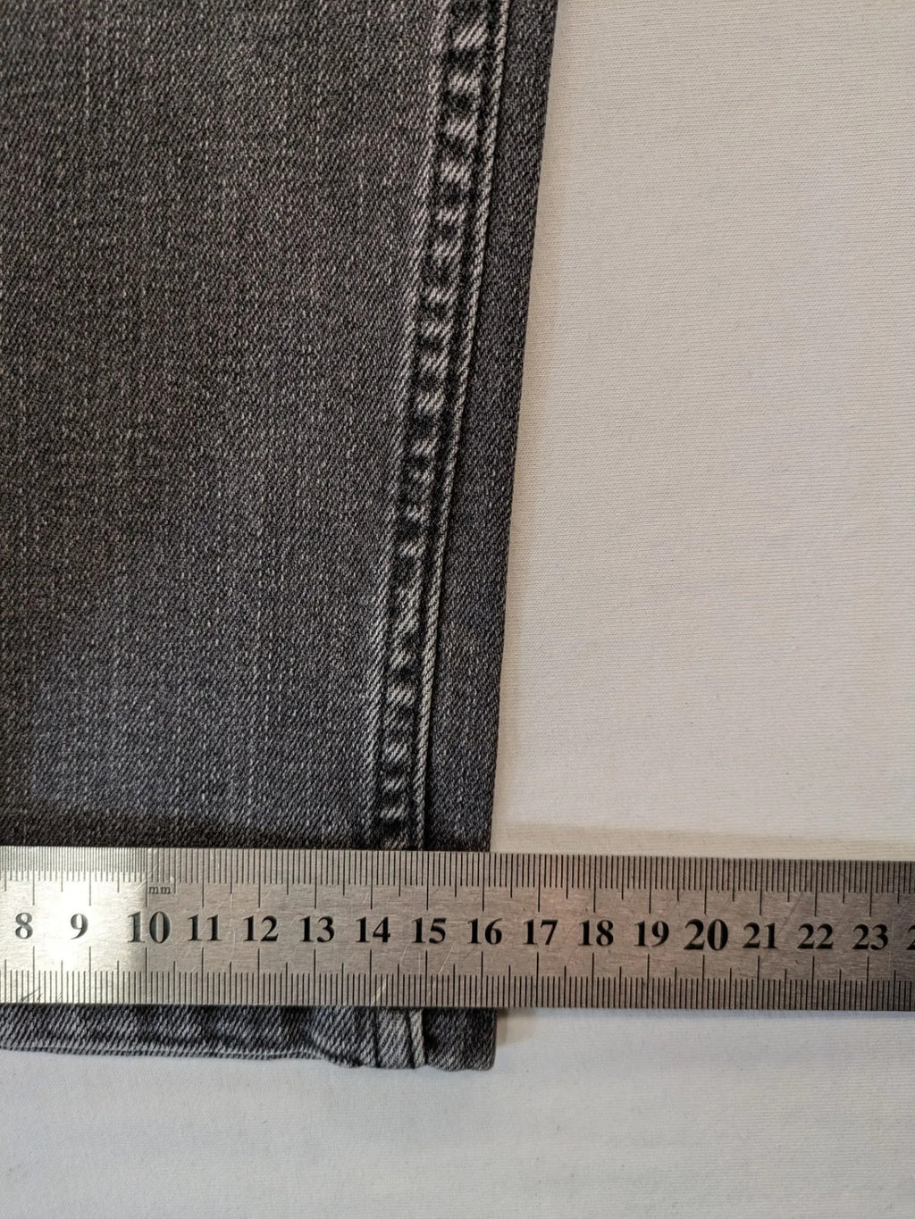 Denim grey straight jeans 5-pocket design with subtle brand details and zipper closure.