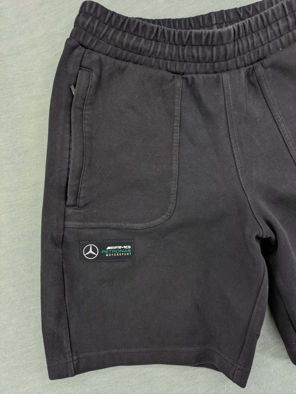 Puma grey sweatshorts featuring Mercedes AMG Petronas logo and elastic waistband.