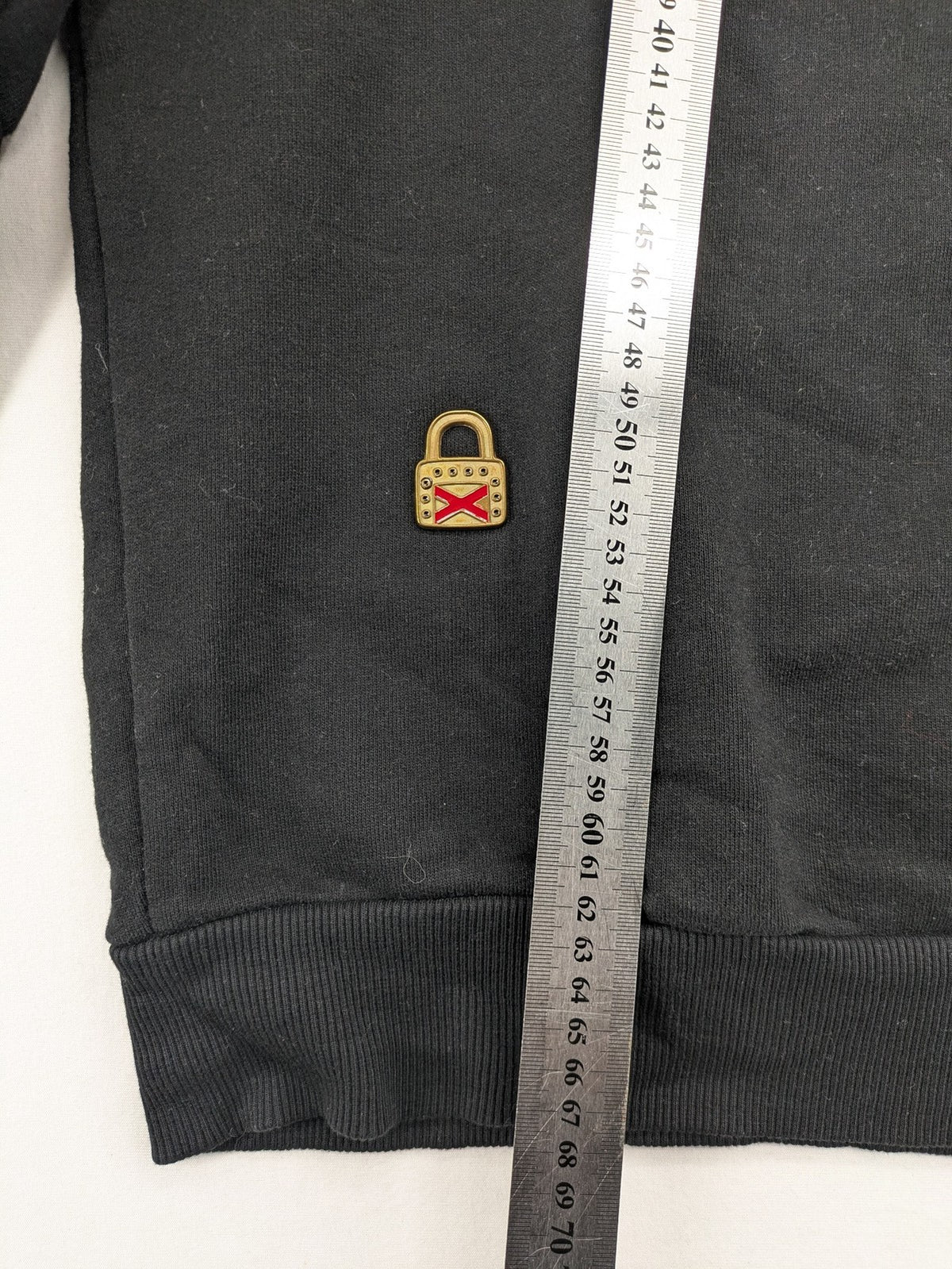 Zara grey turtle neck jumper with skull, scorpion, flame, and eagle embellishments.